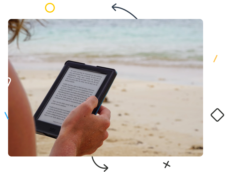 A person reading a Kindle on beach